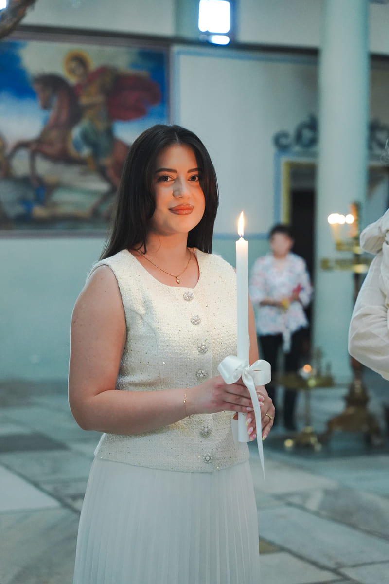 Кръстница със свещ в ръка преди ритуала
